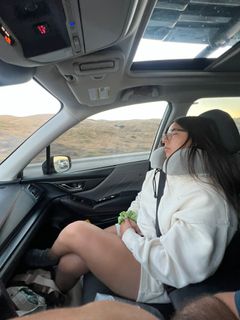 photo of Tu Amiga Amy sleeping in the passenger seat on a road trip on July 1st, 2024.